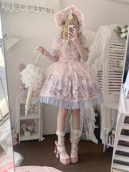 Person wearing a pink Lolita dress with ruffles and embroidery, standing in a room.