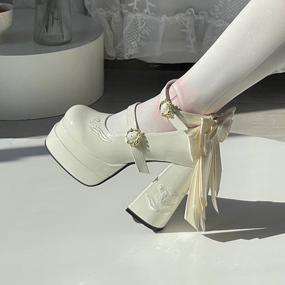 White high-heeled shoes with decorative ribbons on a light background