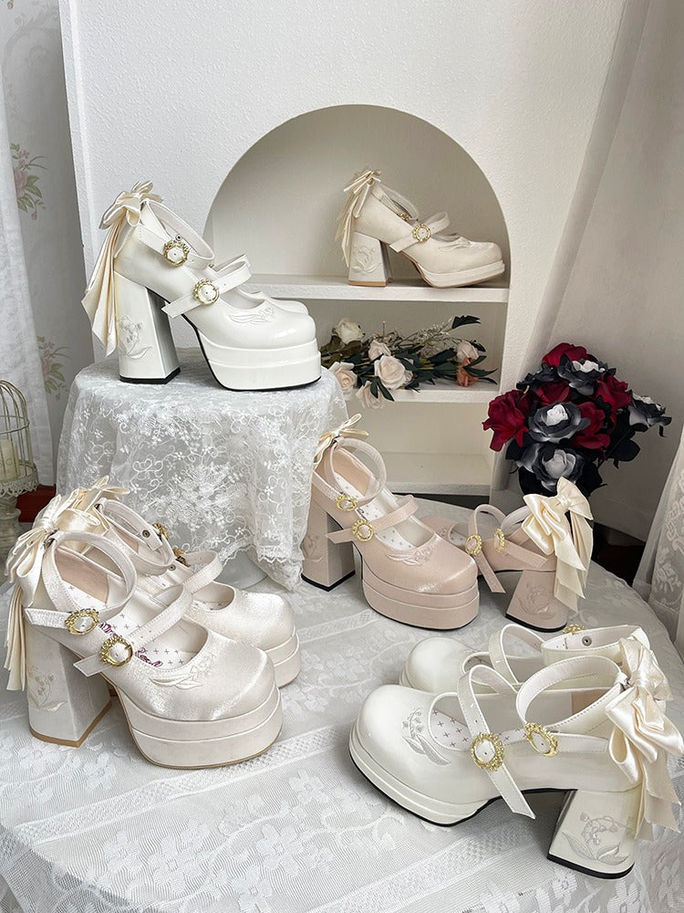 Collection of white high-heeled shoes with decorative ribbons on a lace tablecloth.