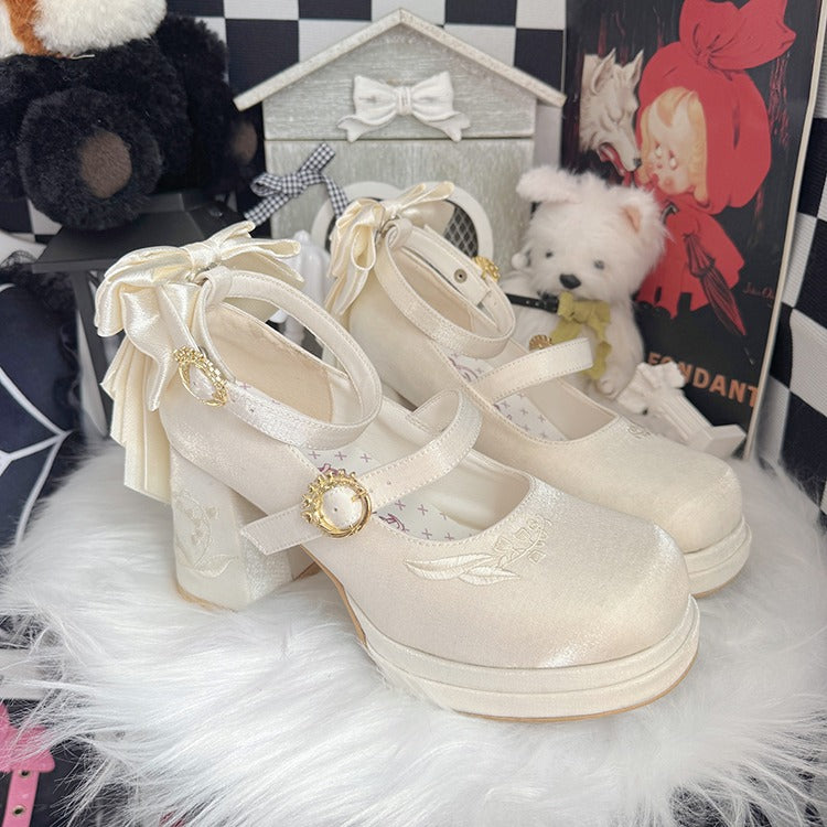 White platform shoes with decorative straps on a fluffy white surface, surrounded by toys and decor items.