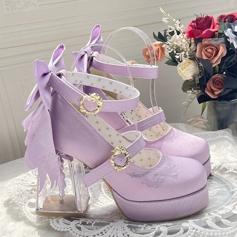 Purple high-heeled shoes with decorative straps and bows on a lace surface.