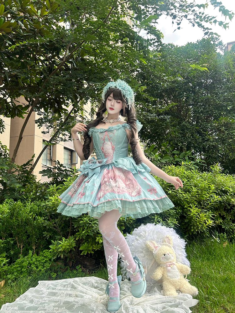 Person in a decorative dress standing outdoors with greenery in the background