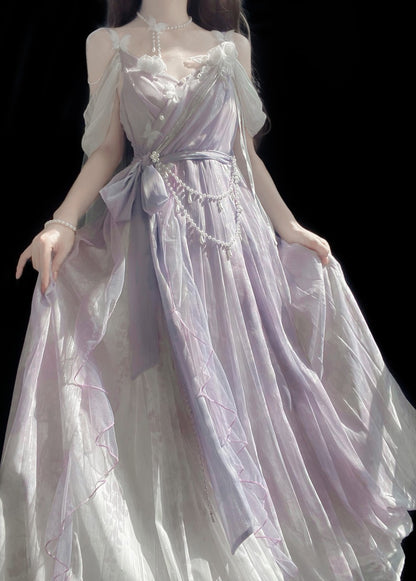 A long, flowing off-the-shoulder dress in a pale lavender and white sheer fabric, shown on a mannequin or doll against a solid black background.