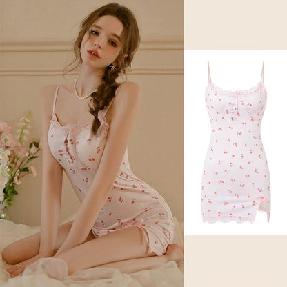 A woman wearing a light pink floral slip dress sits on a bed, with a smaller inset image on the right showing the dress alone against a plain light background. The dress has thin straps, a fitted silhouette, and a small allover floral print.