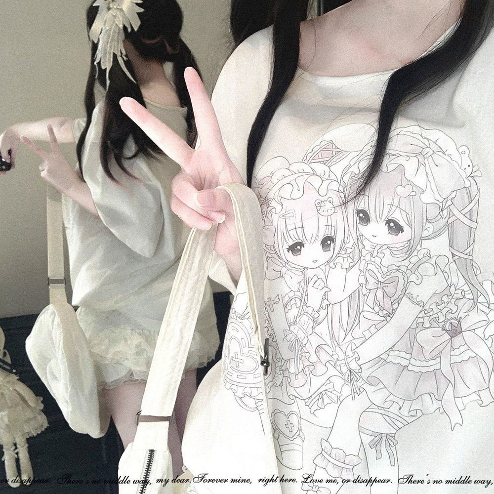 A close-up lifestyle shot of a person wearing a cream-colored oversized T-shirt with a detailed anime-style line art graphic of two chibi girls. The person is holding a matching cream shoulder bag and posing in front of a mirror that reflects the full outfit, which consists of a matching cream dress and a white bow headband.