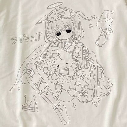 A close-up of a white fabric surface featuring a black line-art graphic of an anime-style angel character holding a rabbit, with small doodle elements and Japanese text.