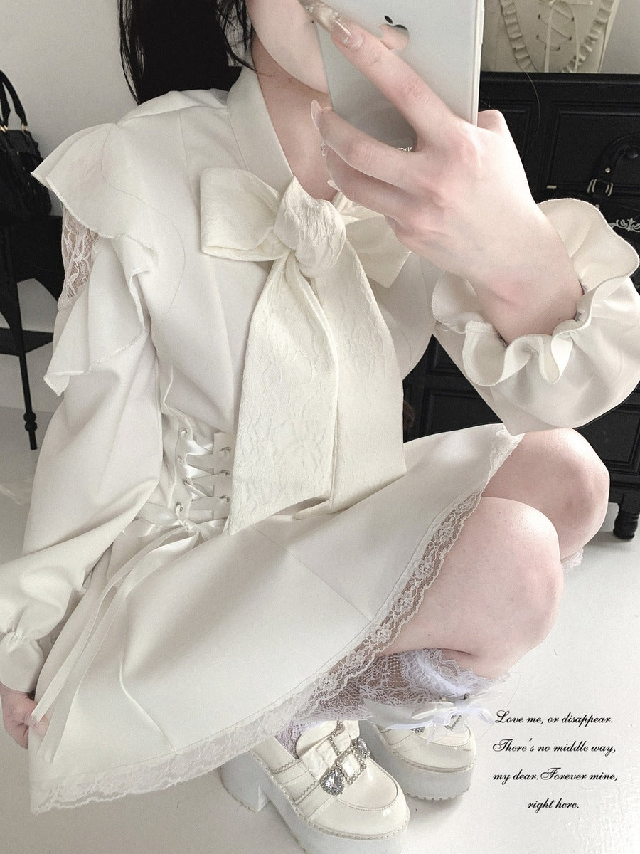 A person takes a mirror selfie wearing a cream-colored Lolita-style dress with a large bow, lace details, and ruffled sleeves, paired with white platform shoes.