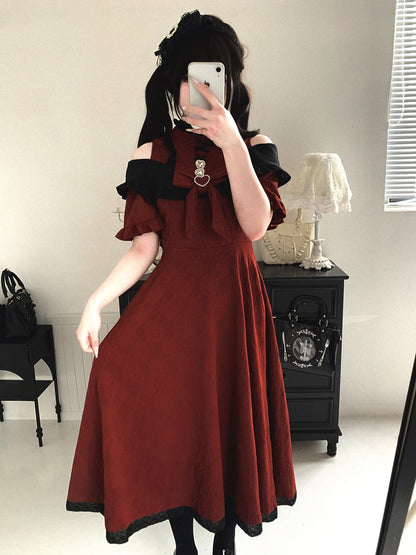 Person wearing a red dress with black trim in a room.