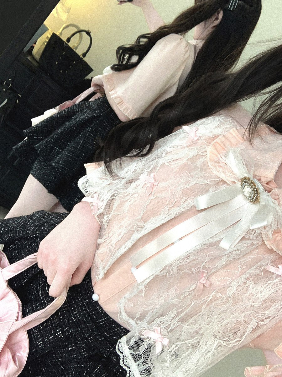 Person wearing a black outfit with a white lace top, sitting in a car.