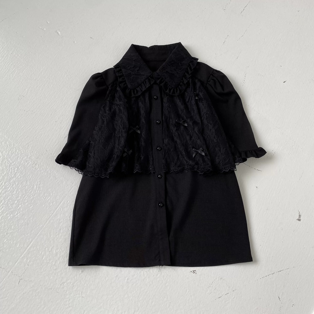 Black ruffled blouse and skirt set on a white background