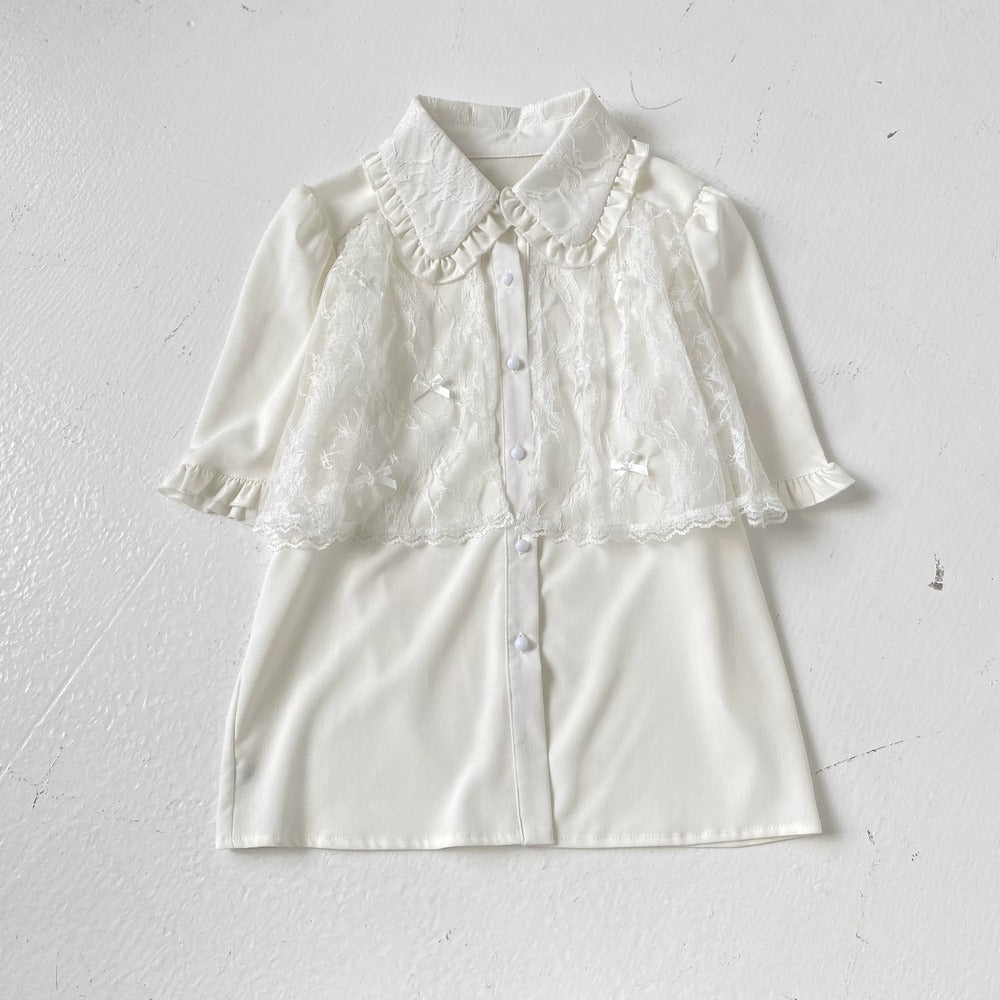 White blouse with lace details on a light gray background