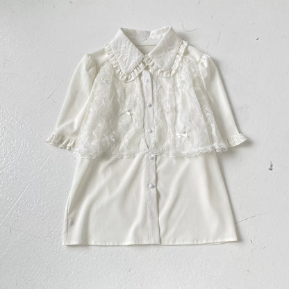White blouse with lace details on a light gray background