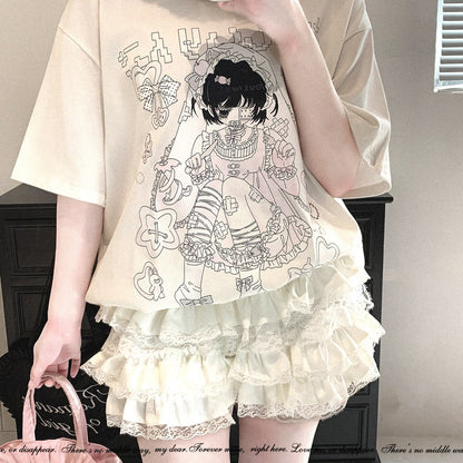 A person wearing a cream-colored oversized graphic T-shirt with a black line-art anime illustration and a matching cream ruffled lace skirt, holding a pink handbag in an indoor setting.