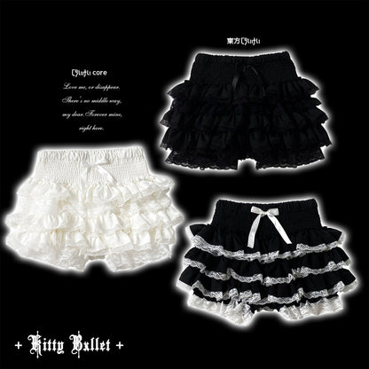 Three pairs of ruffled baby shorts displayed on a black background: one white pair, one black pair, and one black-and-white tiered pair with a white bow.