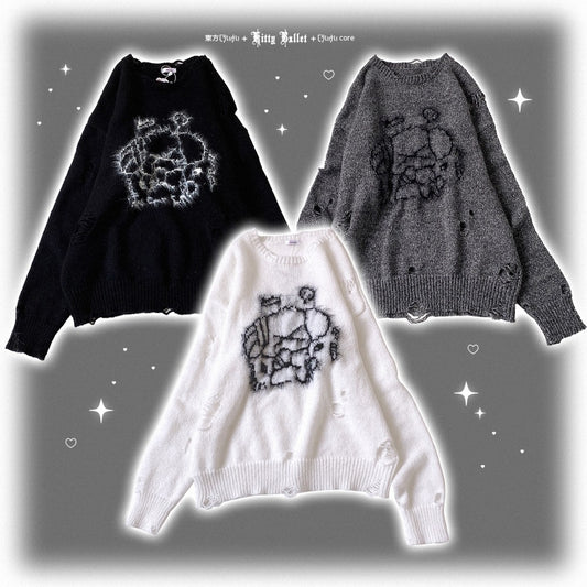 Three sweaters in black, white, and gray with a floral pattern on a gray background.