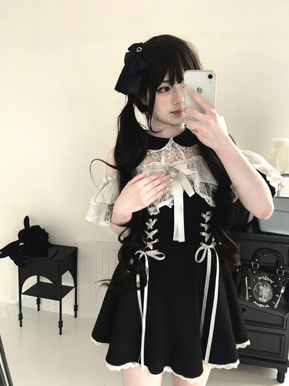 Person wearing a black and white outfit with lace details, taking a mirror selfie.