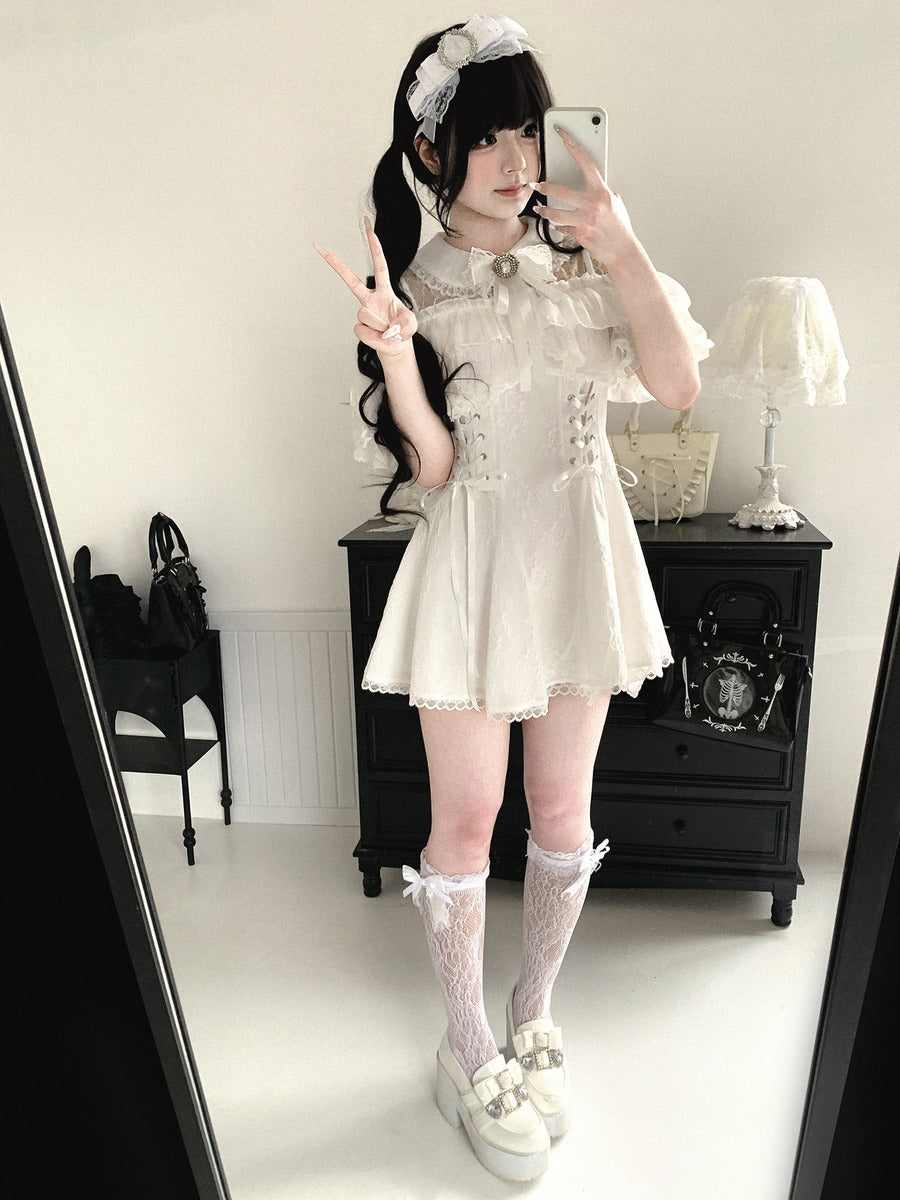 Person wearing a white lace dress with a black background