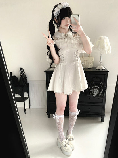 Person wearing a white lace dress with a black background