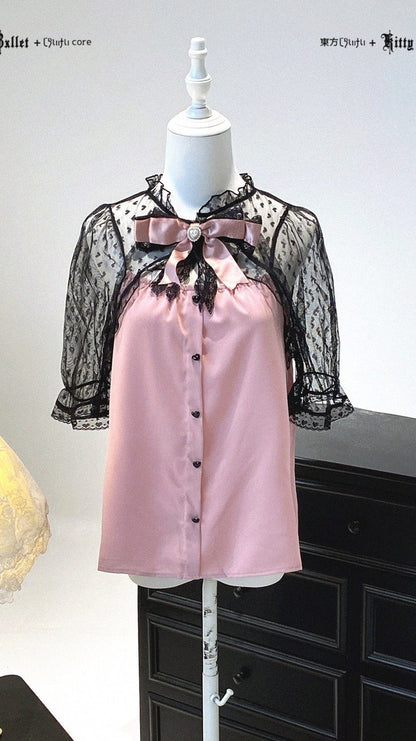 Pink blouse with black lace details on a mannequin against a white background