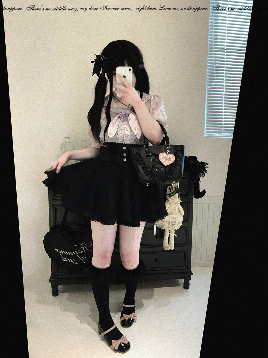 A person takes a mirror selfie wearing a black and white Lolita-style outfit consisting of a ruffled white blouse, a black pleated skirt, a black belt, and black knee-high socks. They are holding a black handbag with a heart-shaped charm.