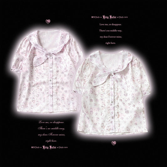 Two short-sleeve button-front blouse tops with a ruffled collar and bow detail, shown on a black background. The left top is light pink with a subtle floral print, and the right top is white with a similar light pink floral print.