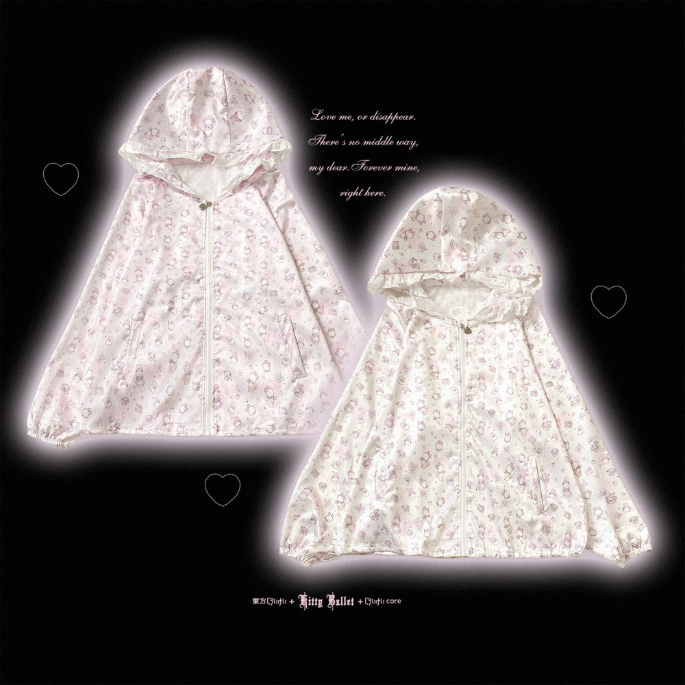 Two hooded zip-front rain ponchos in a very light pink and white floral print, displayed against a black background with a glowing white halo effect around each garment and small heart icons.