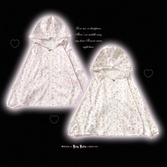 Two hooded zip-front rain ponchos in a very light pink and white floral print, displayed against a black background with a glowing white halo effect around each garment and small heart icons.