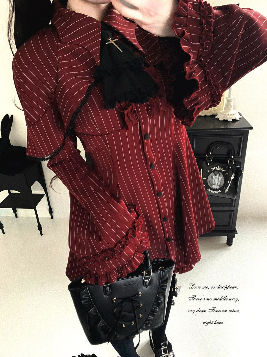 Person wearing a red pinstripe jacket with ruffles in an indoor setting.