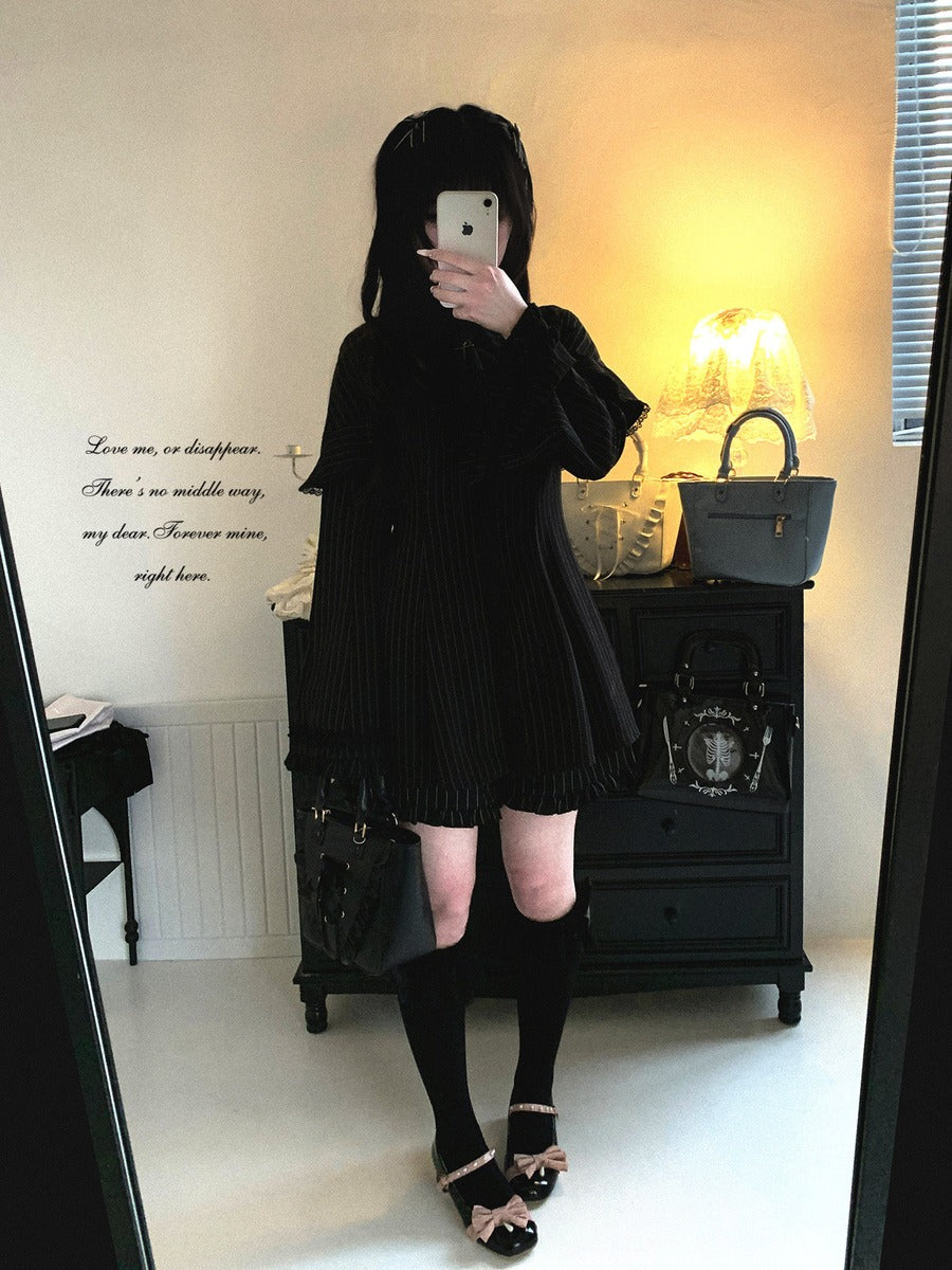 Person wearing a black outfit with a matching bag in a room.