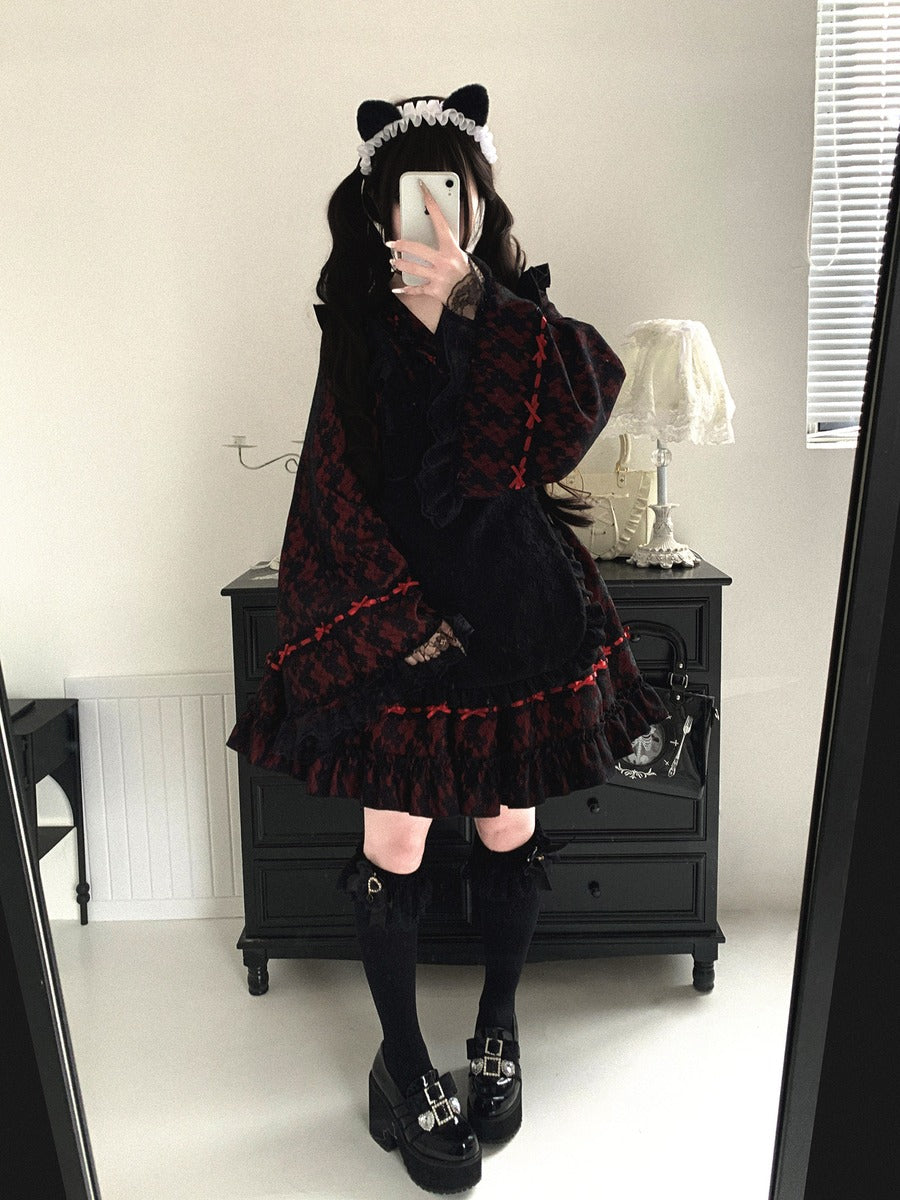 Person wearing a dark, ruffled kimono outfit with cat ears in a room.
