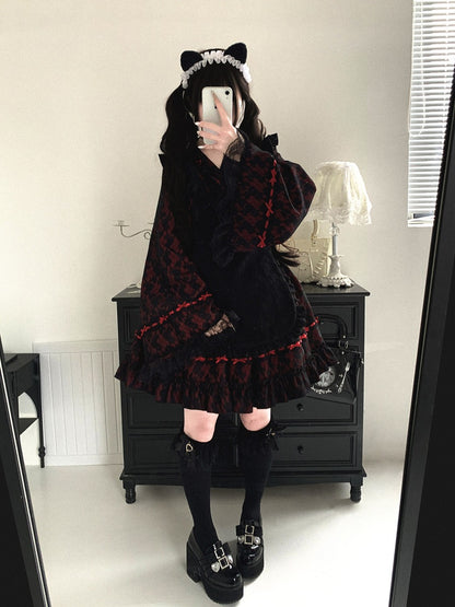 Person wearing a dark, ruffled kimono outfit with cat ears in a room.
