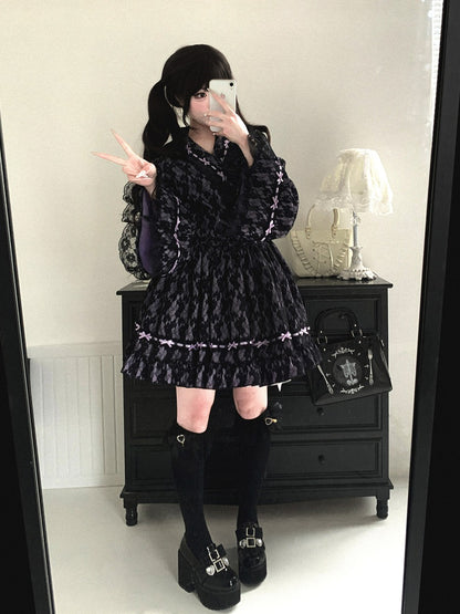 Person wearing a black patterned kimono dress with knee-high boots in a room.