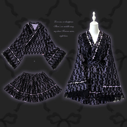 Black purple kimono dress with white accents on a mannequin against a dark background.