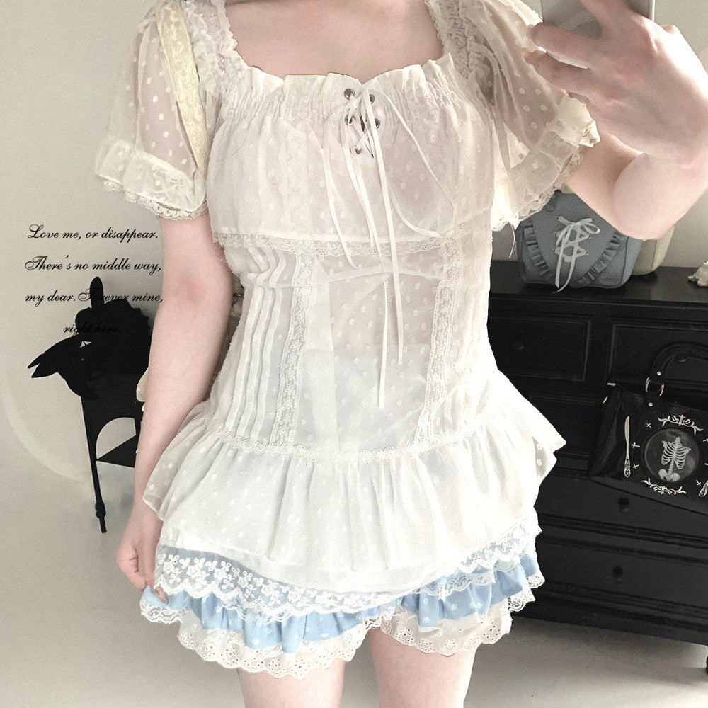Person wearing a white lace dress with a plain background