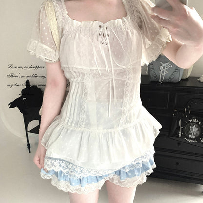 Person wearing a white lace dress with a plain background