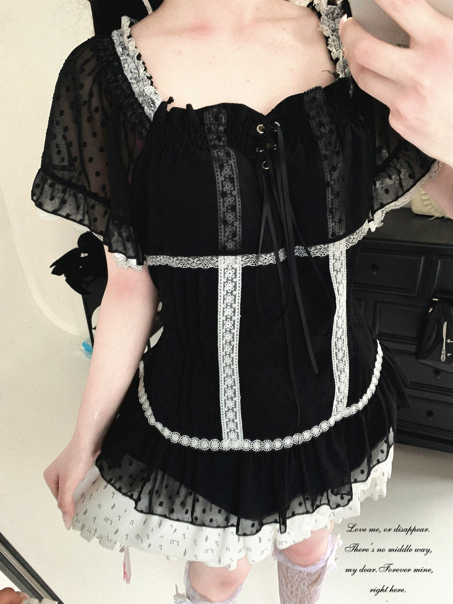 Person wearing a black and white corset with lace details.