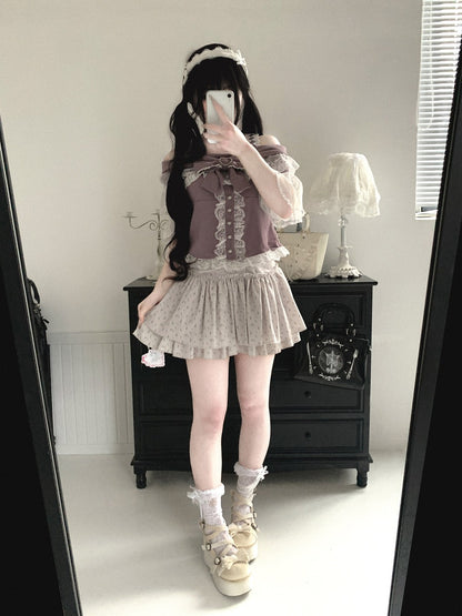 Person taking a mirror selfie wearing a layered outfit with a skirt and top.