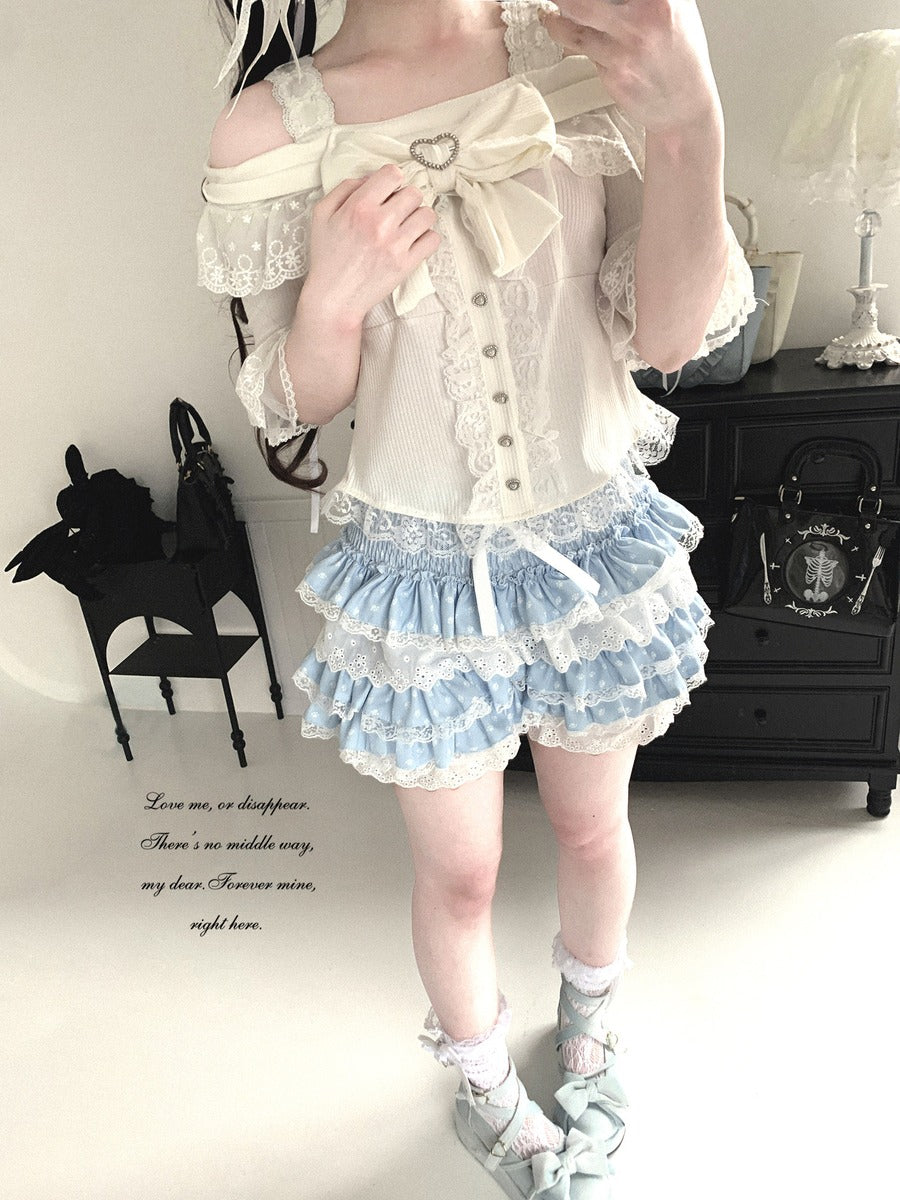 A woman wearing a detailed outfit with ruffles and lace in a room setting.