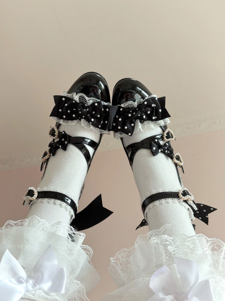 White socks with black bows and ruffles on a beige background