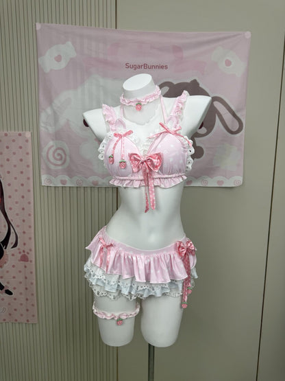 A pink Lolita-style two-piece lingerie set with ruffles, lace, and bows, displayed on a white mannequin torso. The set includes a cropped top with strawberry details and a matching ruffled bottom.
