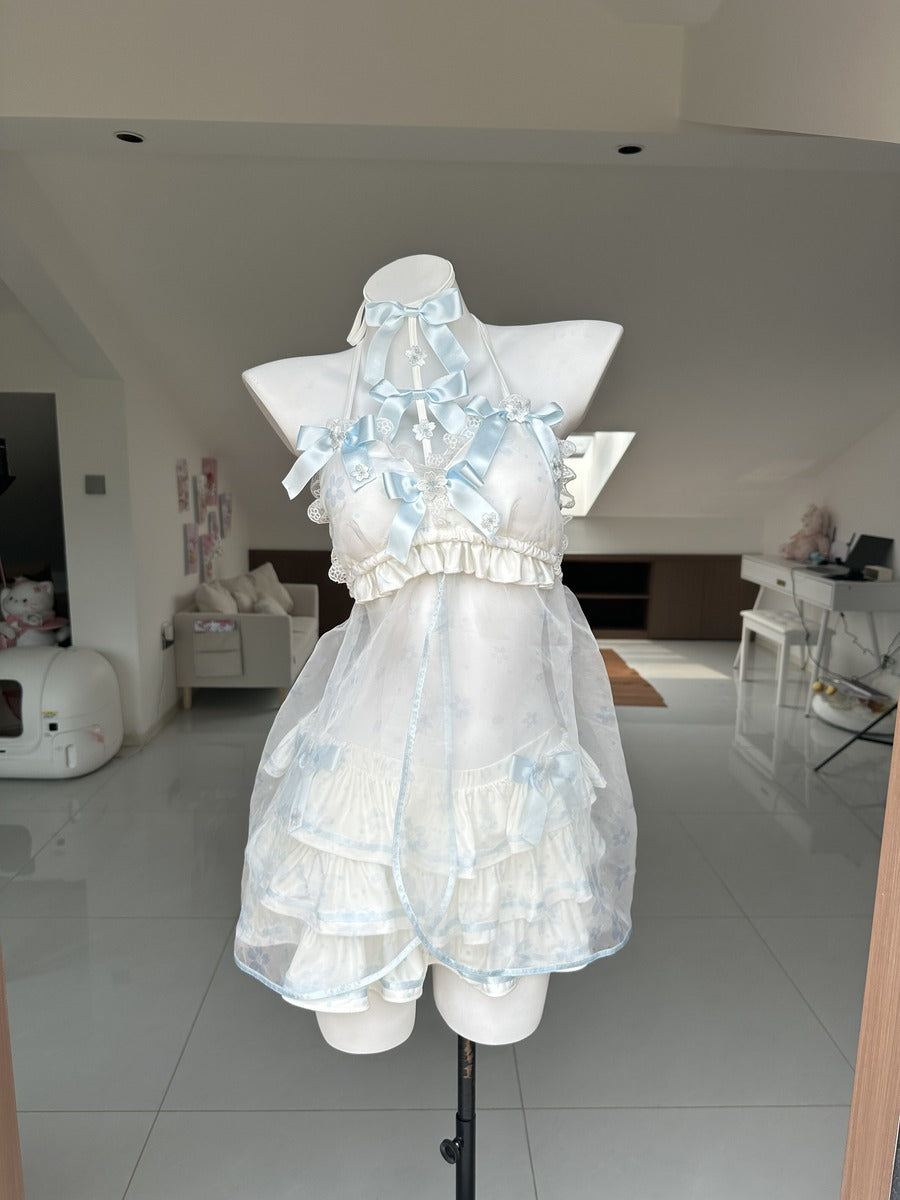 A white and light blue ruffled halter dress displayed on a white mannequin torso in a home interior setting.