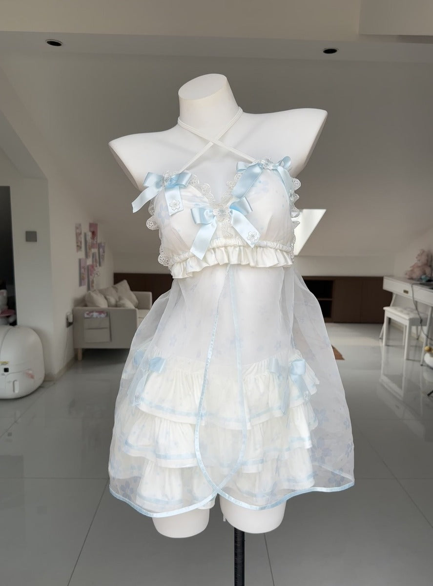 A white and light blue ruffled lingerie-style dress displayed on a white mannequin torso in a bright indoor room.