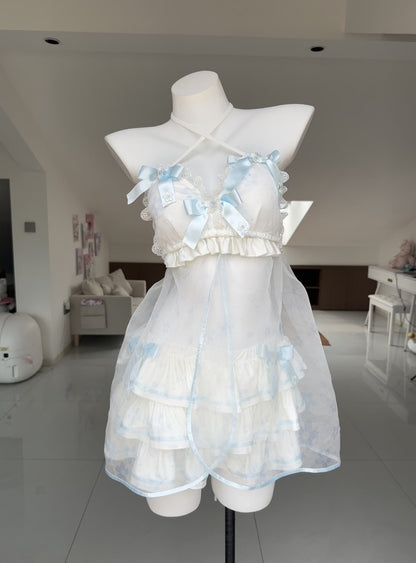 A white and light blue ruffled lingerie-style dress displayed on a white mannequin torso in a bright indoor room.