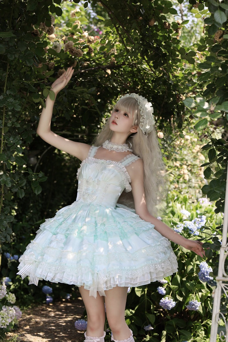 Woman in a white dress with floral decorations standing in a garden.