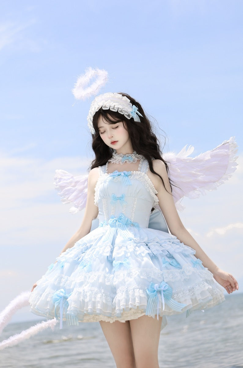 Woman in a fairy costume with wings on a beach