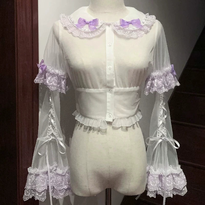 Mannequin wearing a white lace outfit with purple accents on a dark background