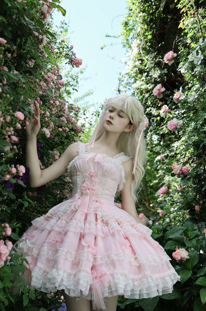 Woman in a pink dress standing among flowers
