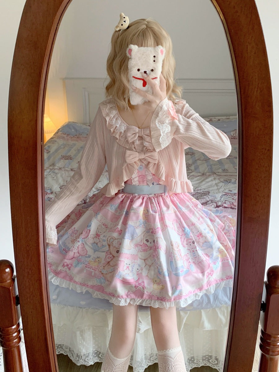 Person wearing a pink and white outfit with a floral skirt, standing in front of a mirror.