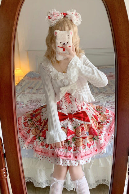 Person wearing a white dress with red accents and floral patterns in front of a mirror.