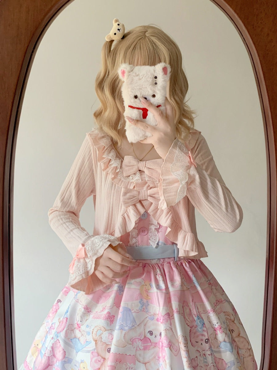 Person wearing a pink outfit with a floral skirt, holding a plush toy in front of their face.